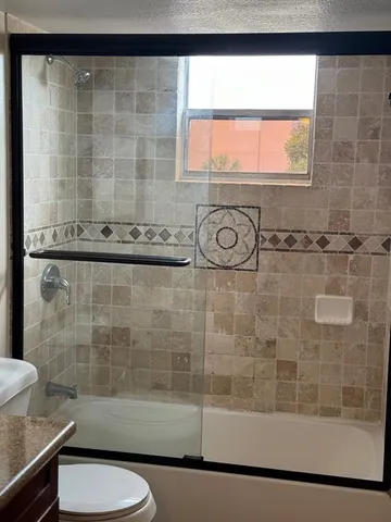 a bathroom with a shower and a sink