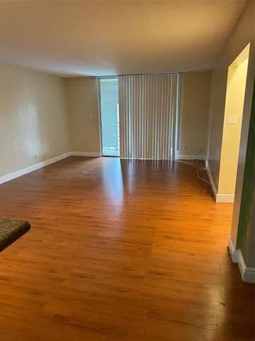 a view of a water heater room with wooden floor