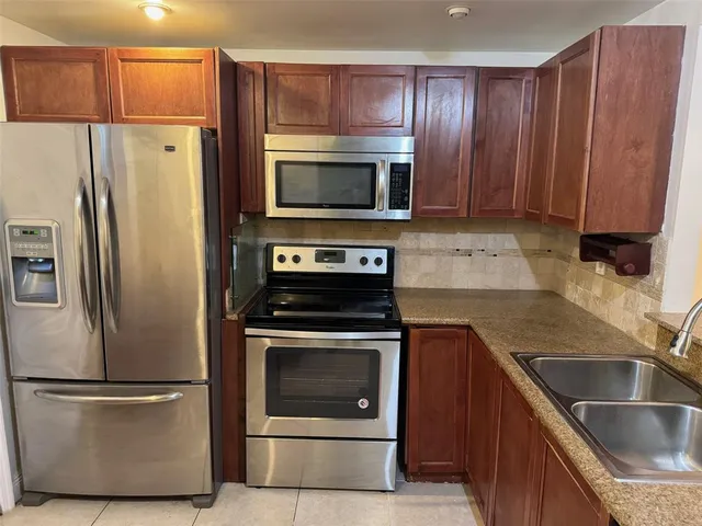 a kitchen with a refrigerator stove and microwave