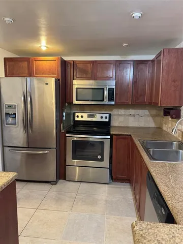 a kitchen with a stove microwave and refrigerator