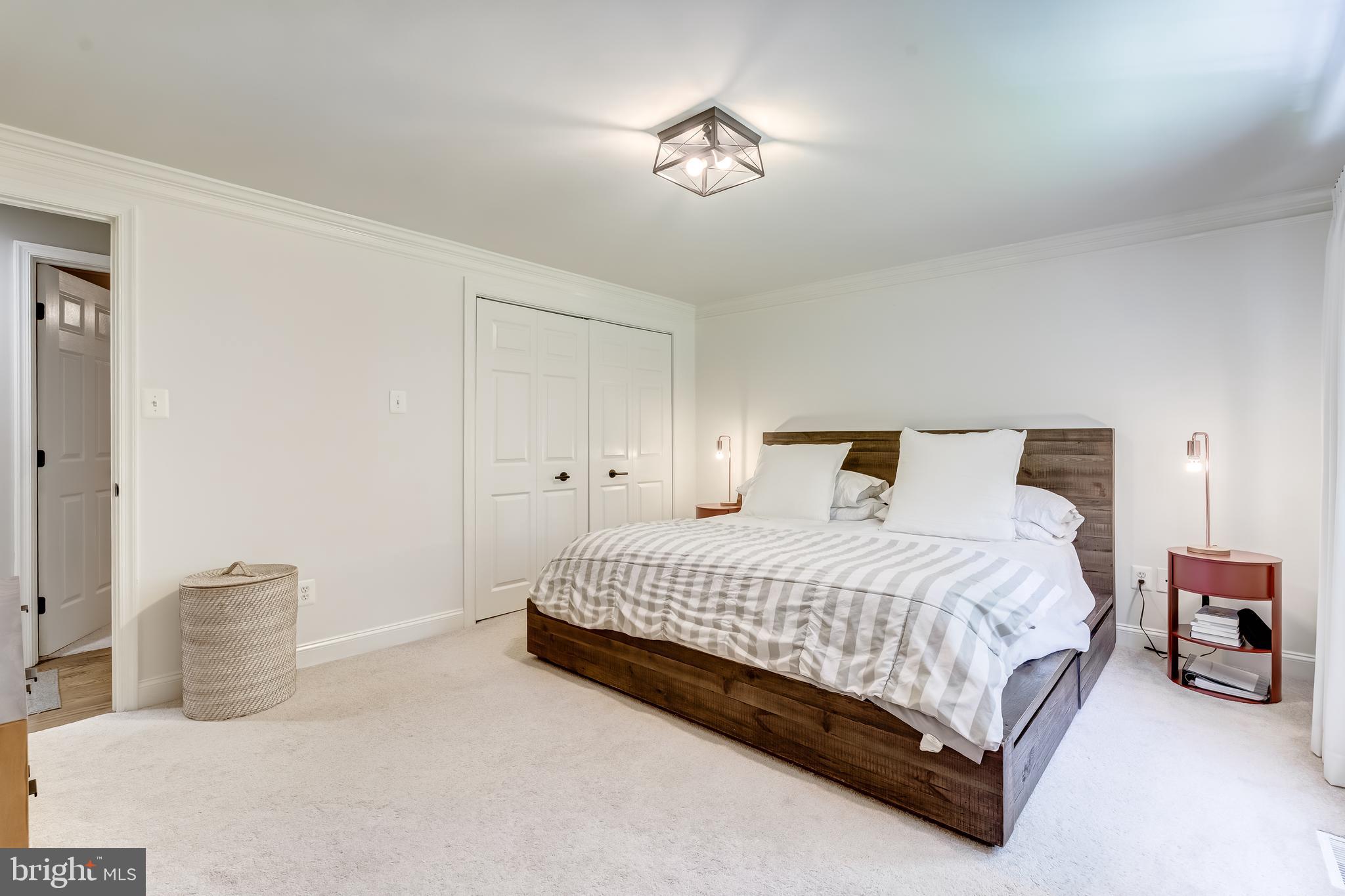 11926 Appling Valley Road Fairfax, VA 22030 - Photo 38 of 60 a bedroom with a bed and a chandelier