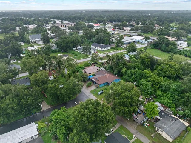 an aerial view of residential house with green space