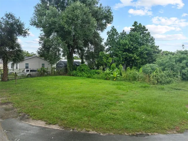 a view of house with backyard