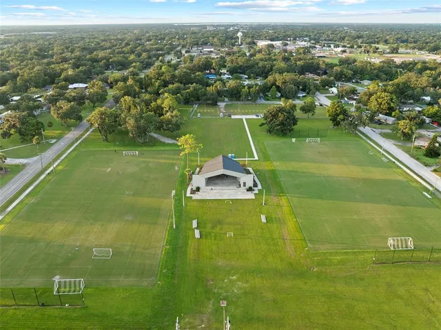 an aerial view of a swimming pool with a yard
