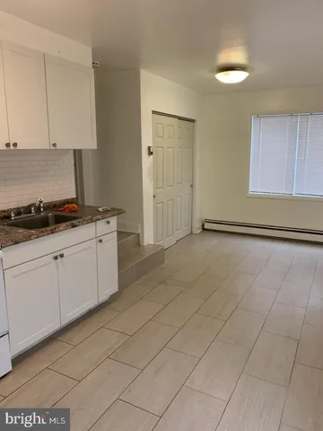 a kitchen with stainless steel appliances granite countertop a sink and cabinets