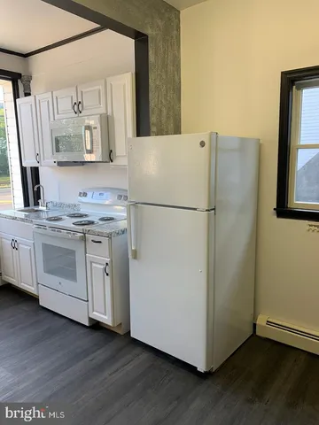 a white refrigerator freezer sitting in a kitchen