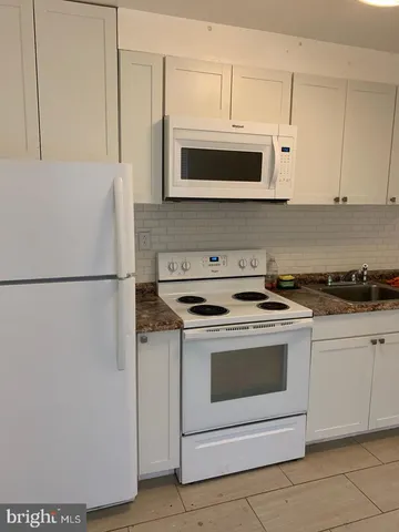 a kitchen with stainless steel appliances granite countertop a stove and a microwave