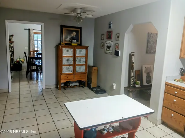 walk in closet with window and fireplace