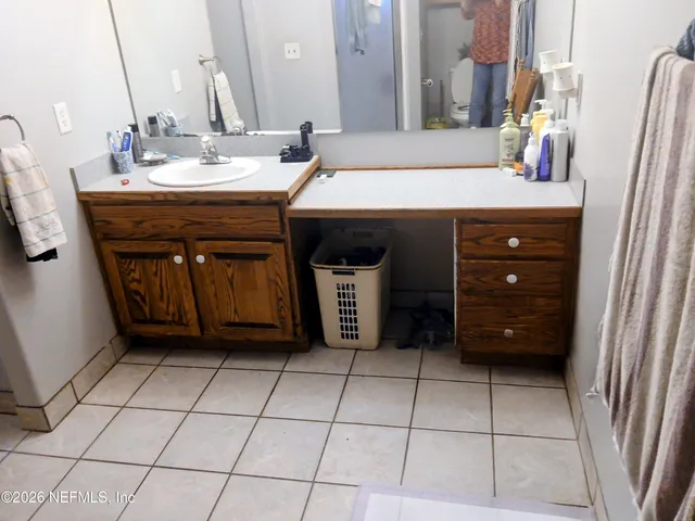 a bedroom with a bed and a mirror