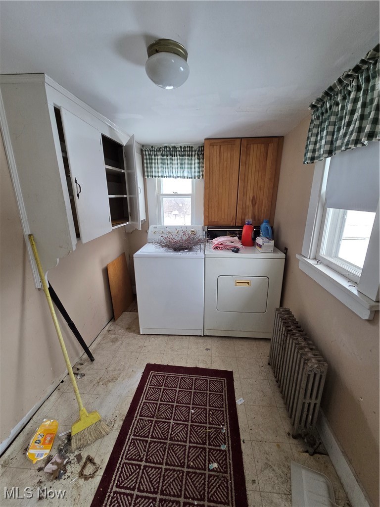 4473 Middle Ridge Road Perry, OH 44081 - Photo 8 of 22 Laundry area with cabinet space, washing machine and clothes dryer, and radiator heating unit