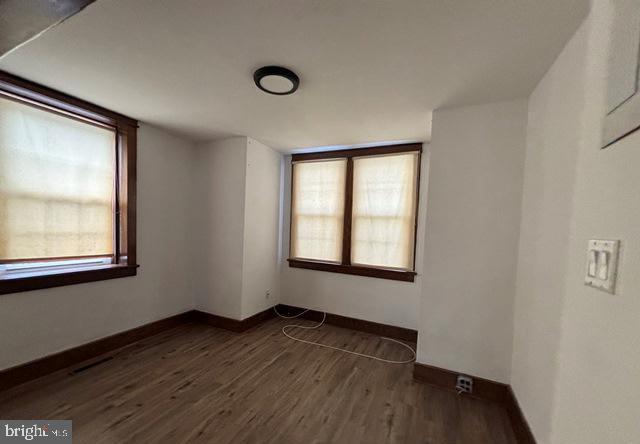 137 Repaupo Station Road Swedesboro, NJ 08085 - Photo 11 of 17 an empty room with wooden floor and windows
