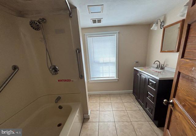 137 Repaupo Station Road Swedesboro, NJ 08085 - Photo 5 of 17 a bathroom with a tub a sink a vanity and a shower