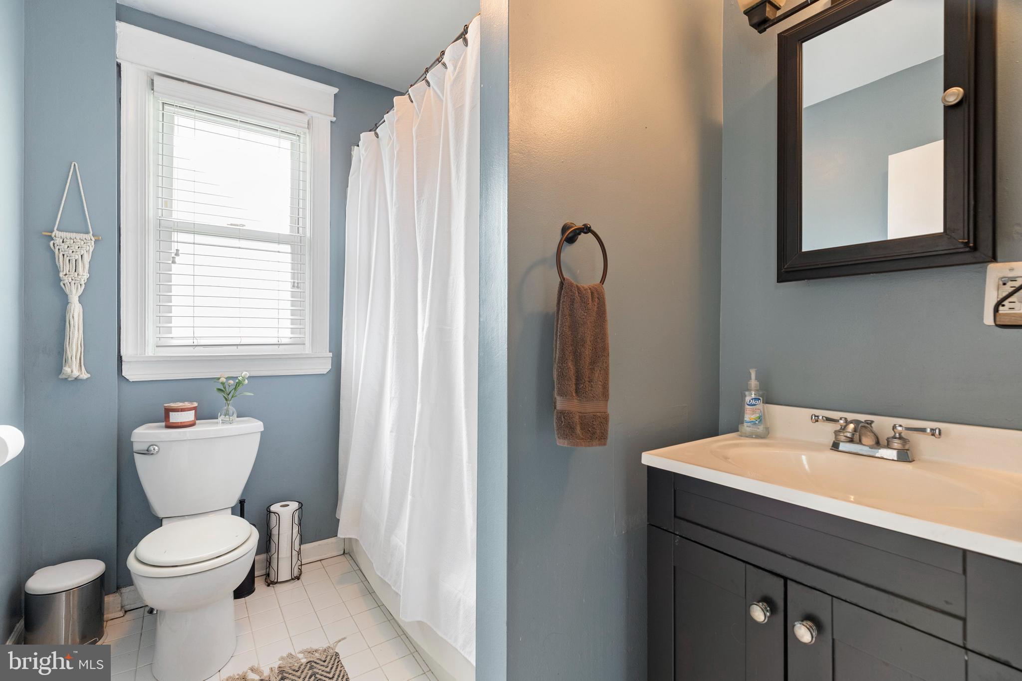 312 South State Road Upper Darby, PA 19082 - Photo 26 of 37 a bathroom with a toilet a sink a vanity and mirror