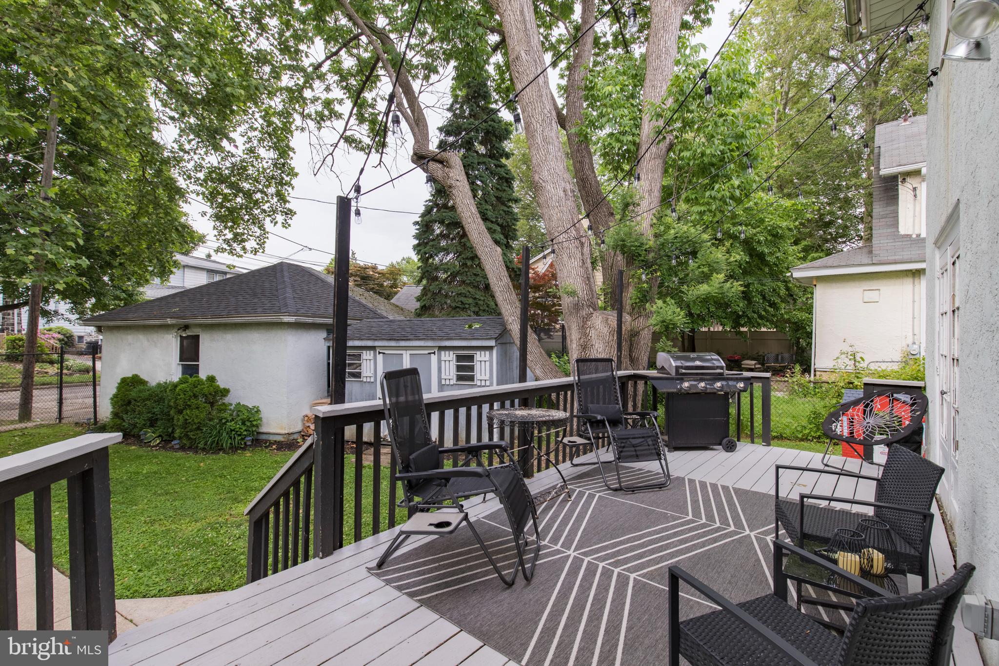 312 South State Road Upper Darby, PA 19082 - Photo 30 of 37 a view of a patio with couches chairs and a table and chairs with wooden floor and fence