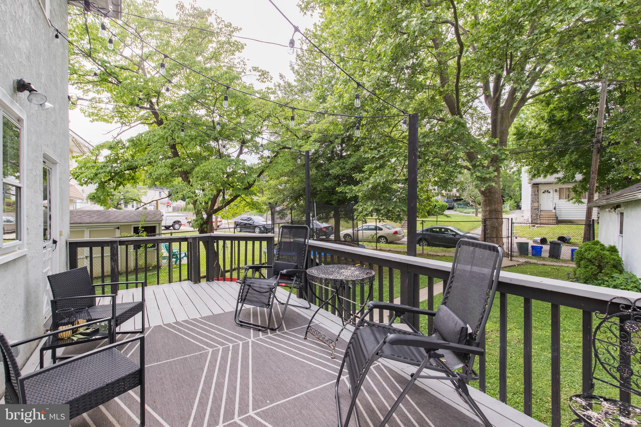 312 South State Road Upper Darby, PA 19082 - Photo 31 of 37 a view of a deck with furniture and trees around