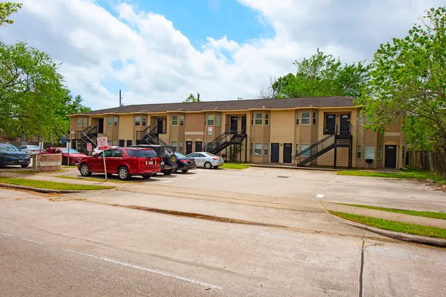 a view of a cars park in front of a house