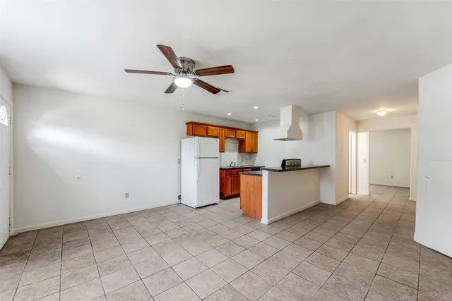 a view of kitchen with stainless steel appliances cabinets and window