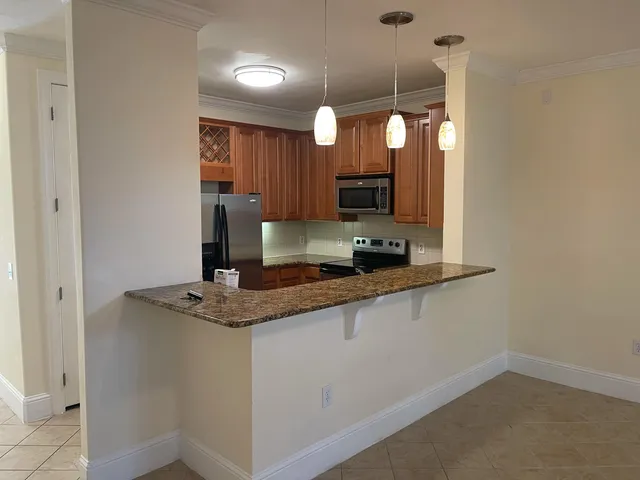 a kitchen with stainless steel appliances granite countertop a sink and a granite counter tops