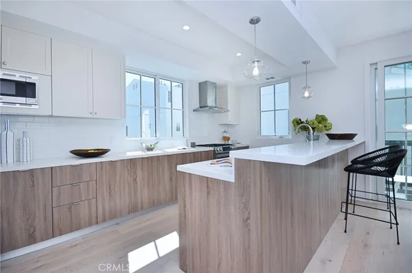 a kitchen with counter top space a sink cabinets and appliances