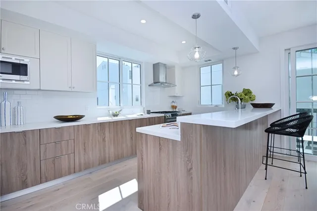 a kitchen with counter top space a sink cabinets and appliances