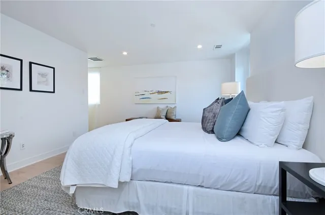 a bedroom with a bed and a lamp