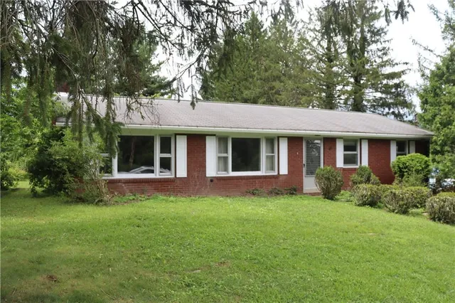 a front view of a house with a garden and porch