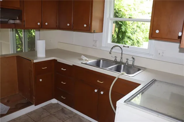 a view of an empty room with a fireplace and a window