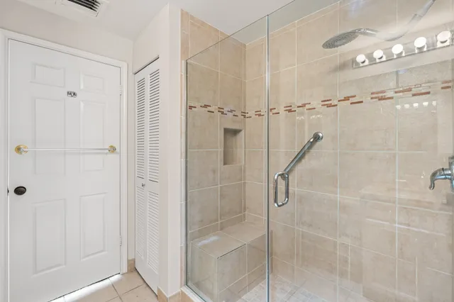 a bathroom with a granite countertop sink shower and a mirror