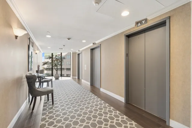 a dining room with furniture and a potted plant