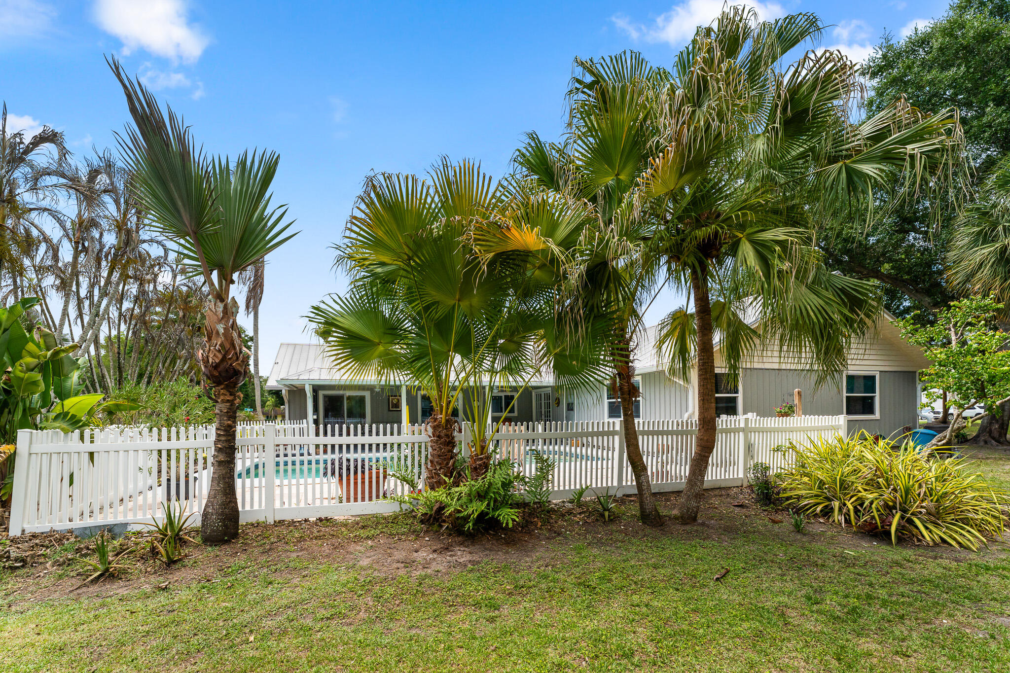 1653 Southwest 85th Terrace Stuart, FL 34997 - Photo 45 of 54 a view of backyard with a garden and palm trees
