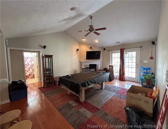 a living room with furniture ceiling fan and a window
