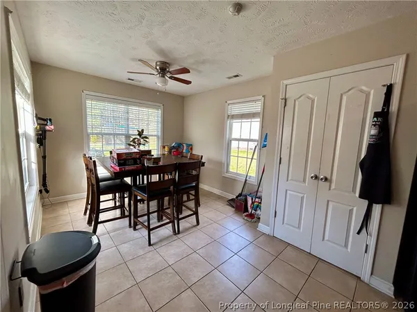 a view of a dining room with furniture and a chandelier