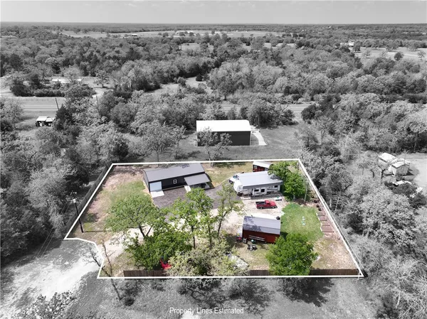 an aerial view of house with yard