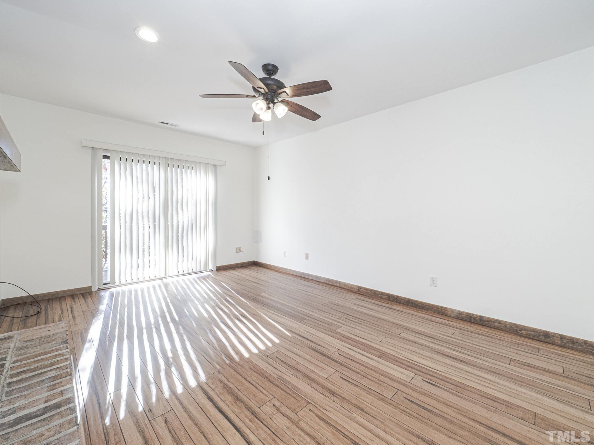 4349 Sunscape Lane Raleigh, NC 27613 - Photo 15 of 28 wooden floor in an empty room with a window