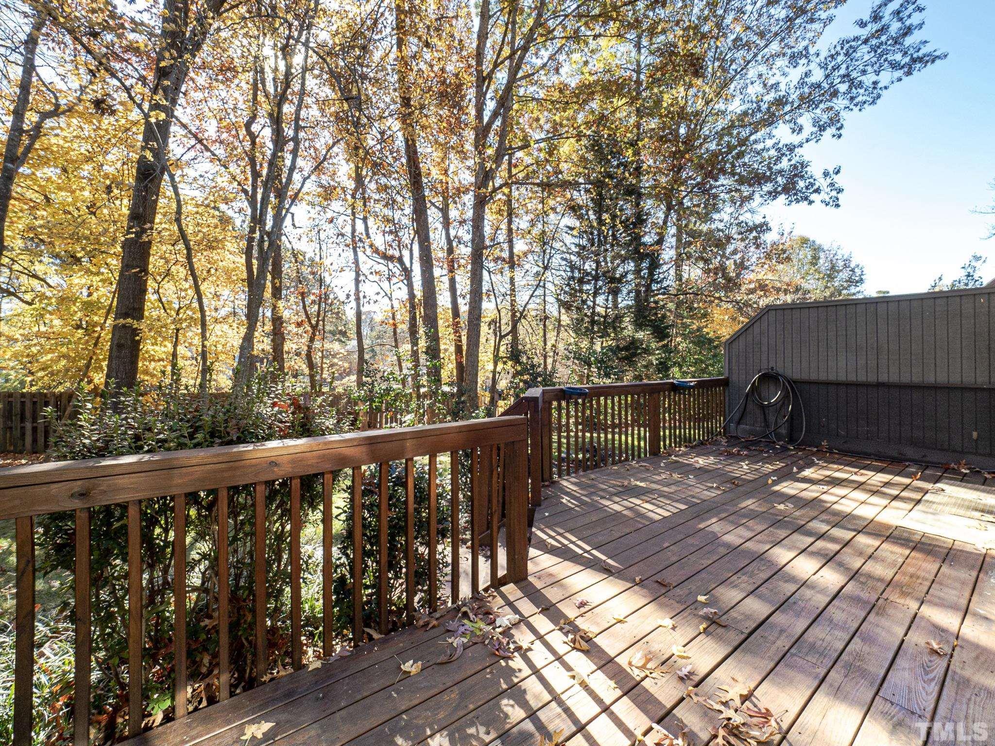 4349 Sunscape Lane Raleigh, NC 27613 - Photo 18 of 28 a view of a wooden deck next to a yard