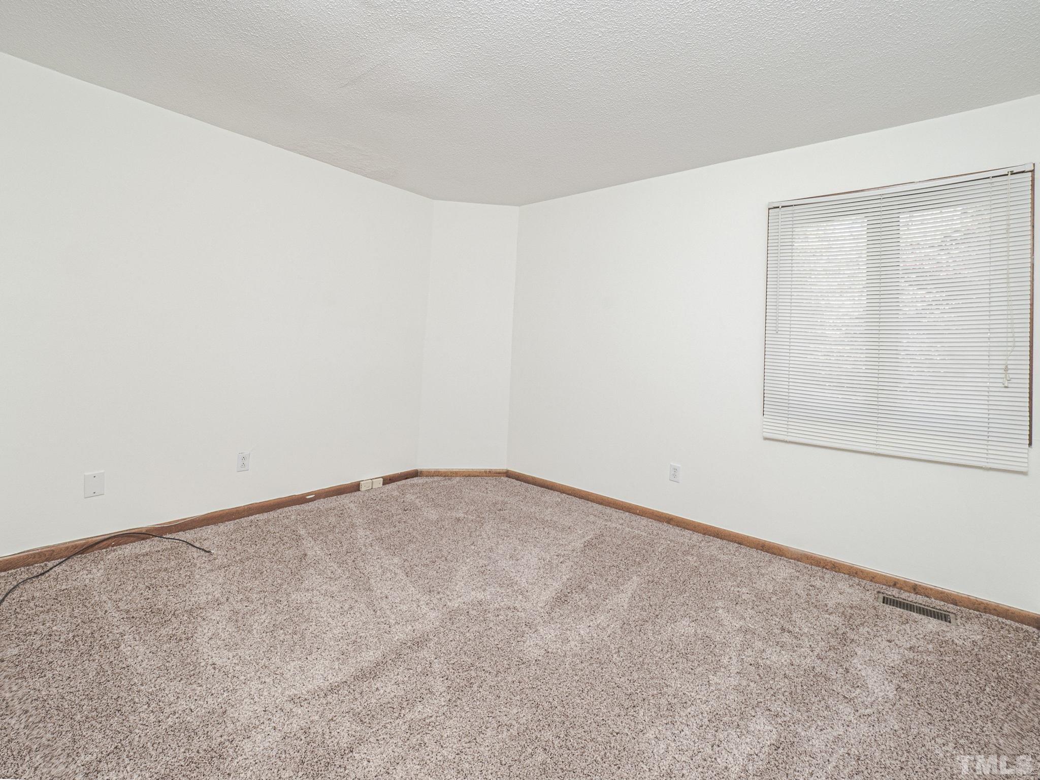 4349 Sunscape Lane Raleigh, NC 27613 - Photo 19 of 28 an empty room with a natural light