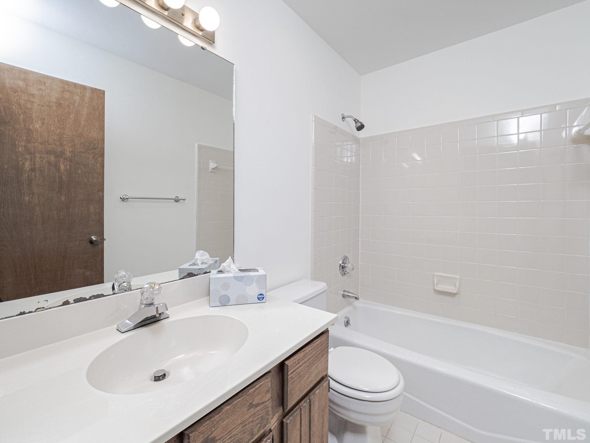 4349 Sunscape Lane Raleigh, NC 27613 - Photo 20 of 28 a bathroom with a sink a toilet and shower