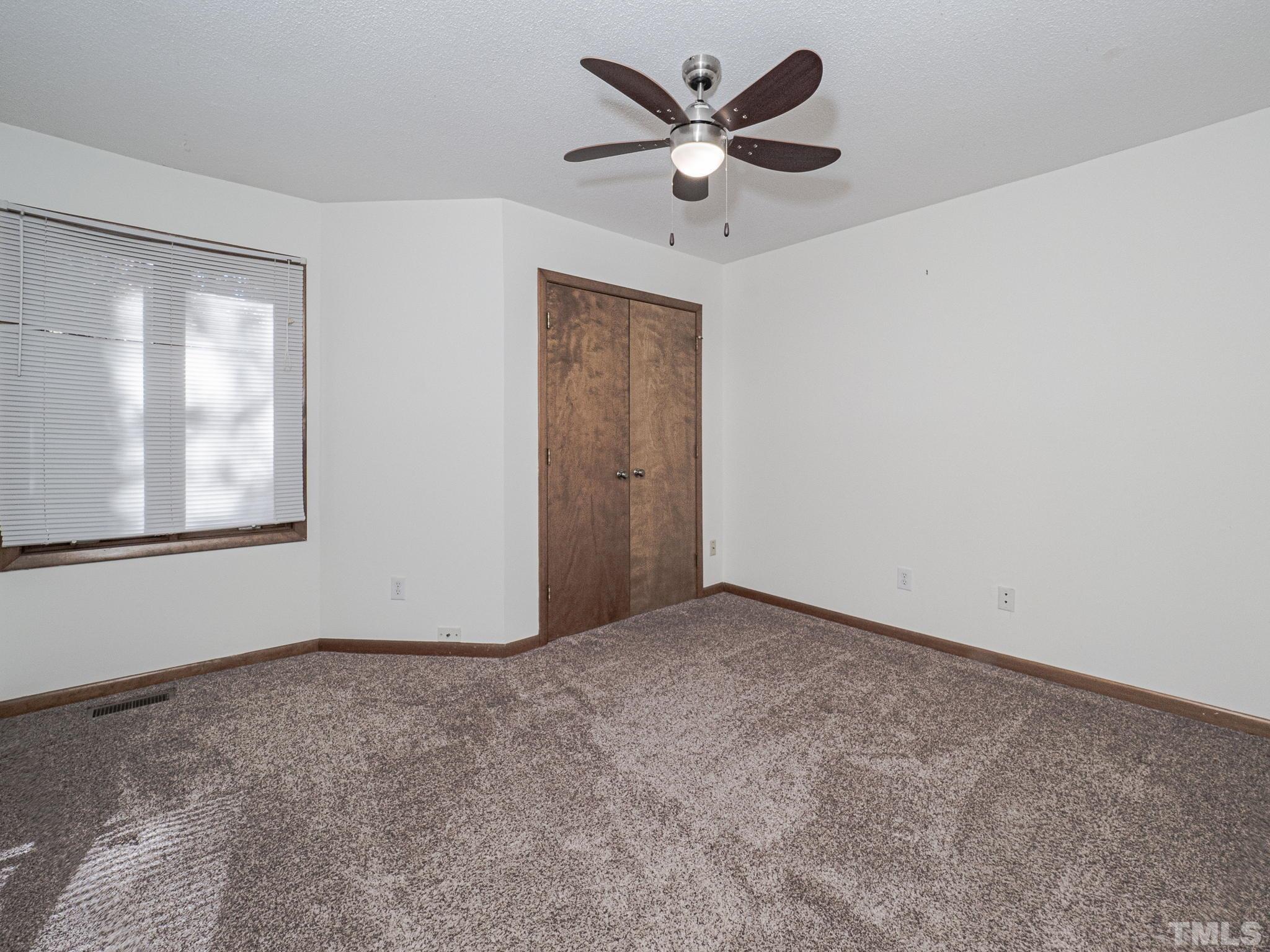 4349 Sunscape Lane Raleigh, NC 27613 - Photo 21 of 28 an empty room with windows and fan