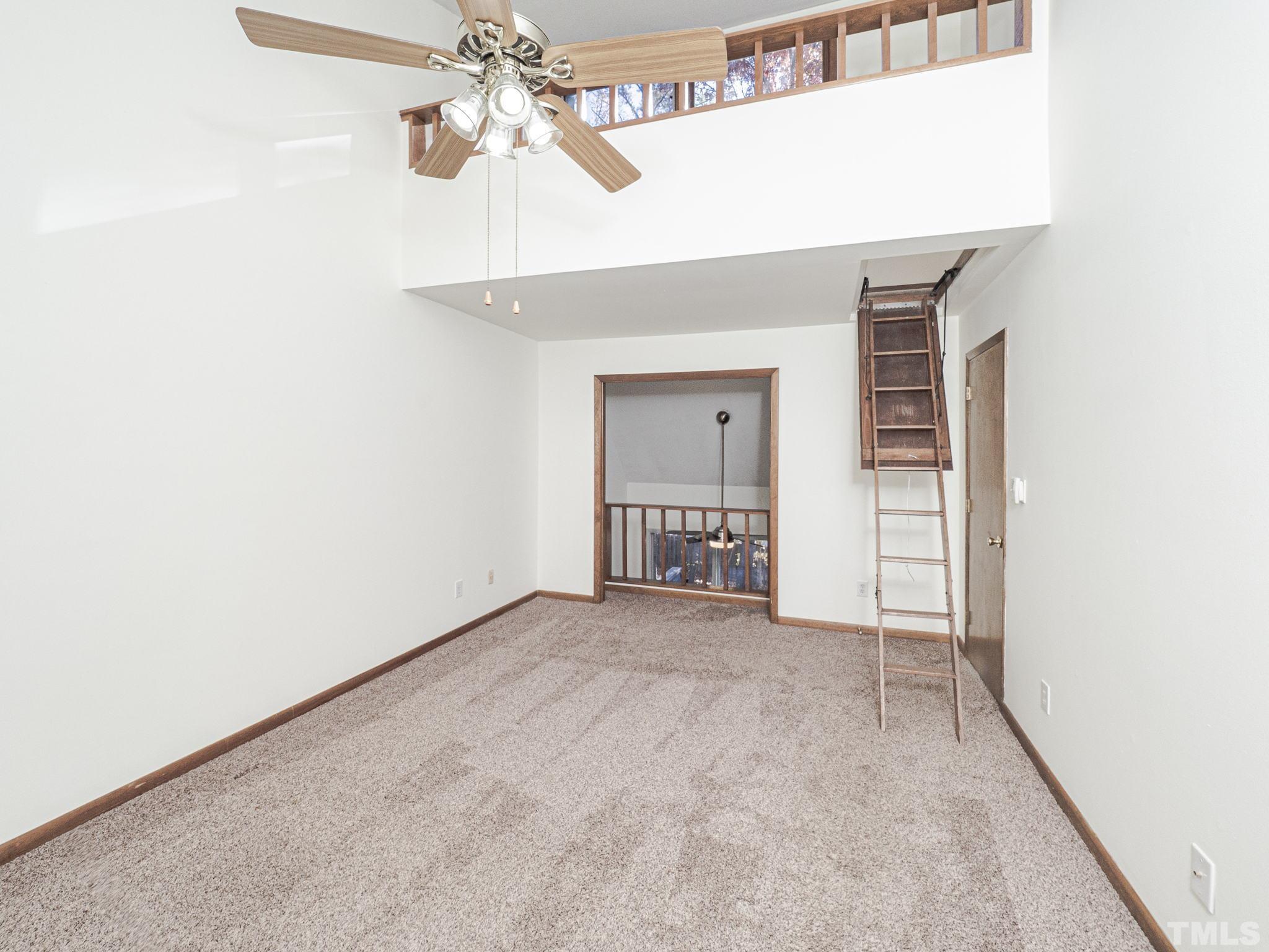 4349 Sunscape Lane Raleigh, NC 27613 - Photo 23 of 28 a view of a livingroom with a ceiling fan and kitchen space