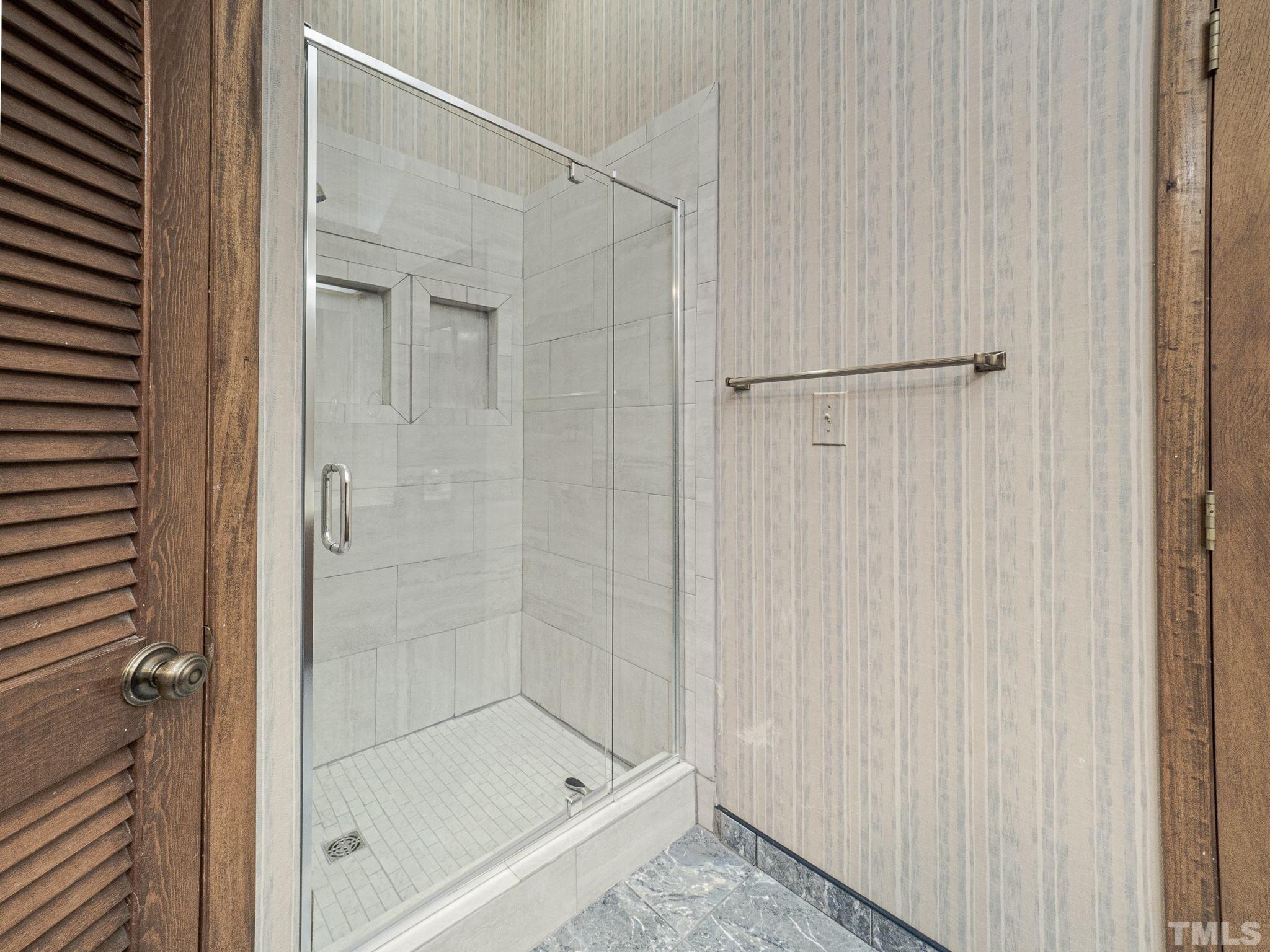 4349 Sunscape Lane Raleigh, NC 27613 - Photo 26 of 28 a bathroom with a glass shower door
