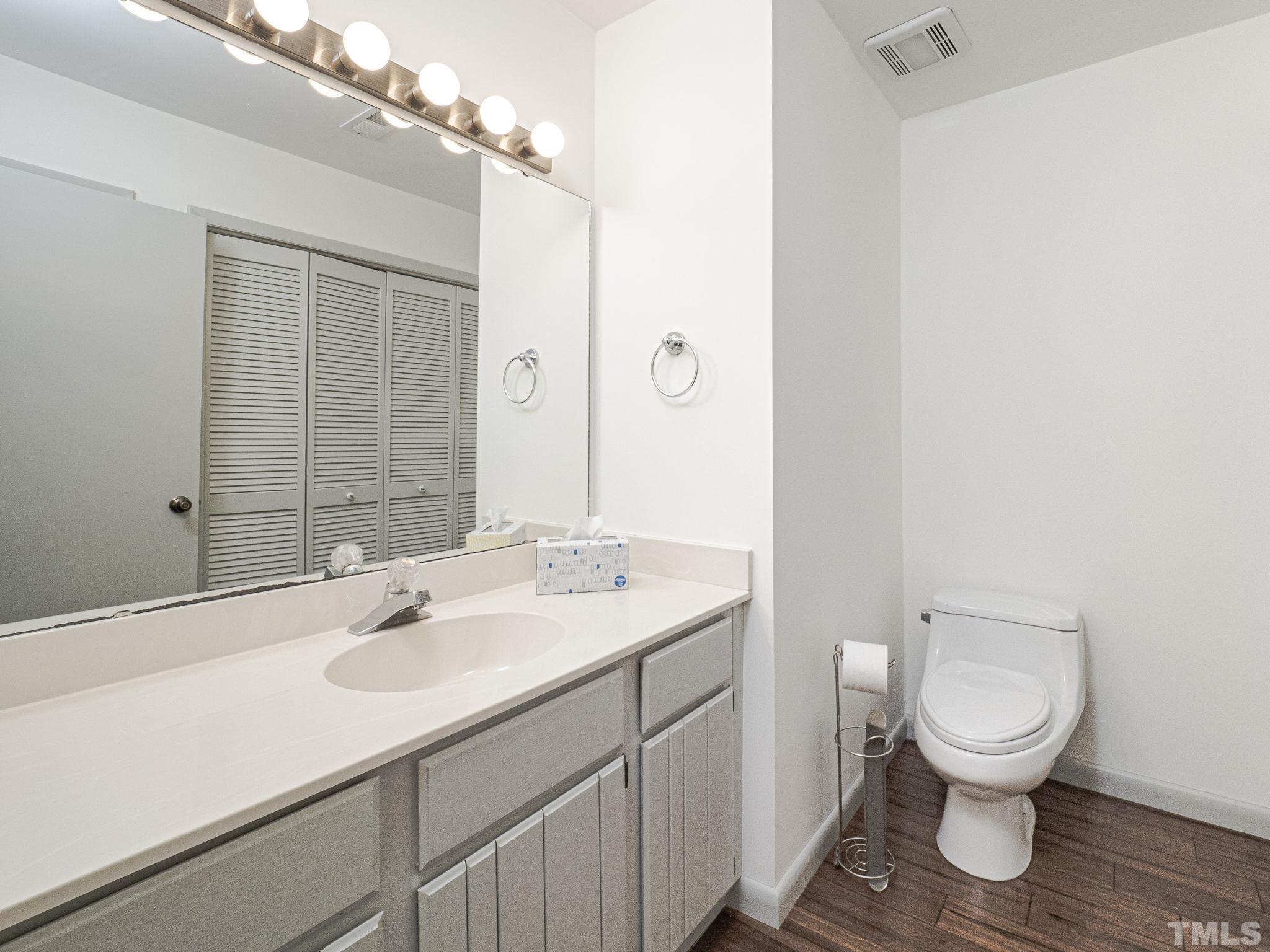 4349 Sunscape Lane Raleigh, NC 27613 - Photo 7 of 28 a bathroom with a sink a toilet and mirror