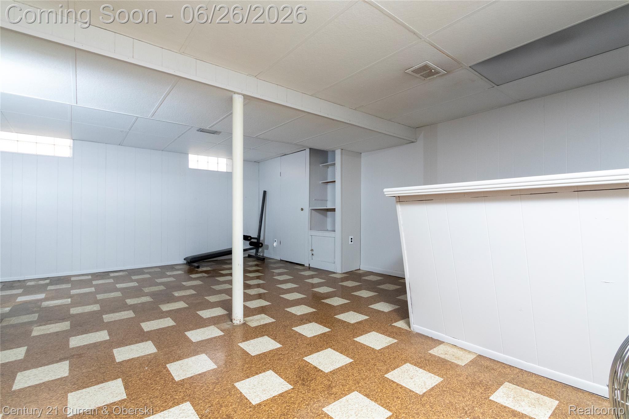 3220 Alice Street Dearborn, MI 48124 - Photo 25 of 39 Spacious lower-level room featuring patterned flooring, white paneling, and a drop ceiling