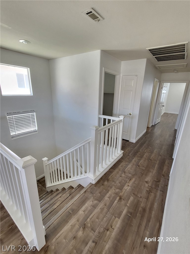 4548 Flaming Ridge Trail Las Vegas, NV 89147 - Photo 19 of 21 Rich wood-textured flooring flows through this bright upper-level hallway overlooking the staircase.