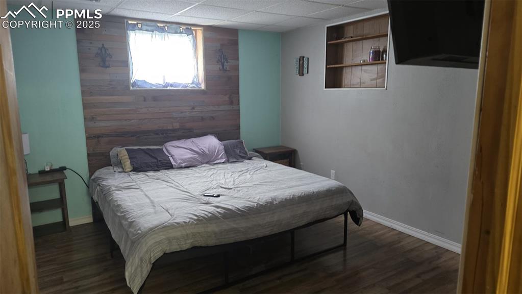 414 Seventh Street Hugo, CO 80821 - Photo 13 of 30 a bedroom with a bed and wooden floor