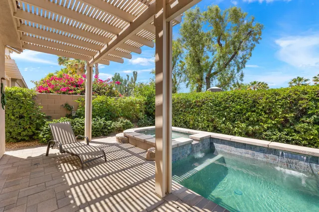 a view of a patio with a table chairs and a garden