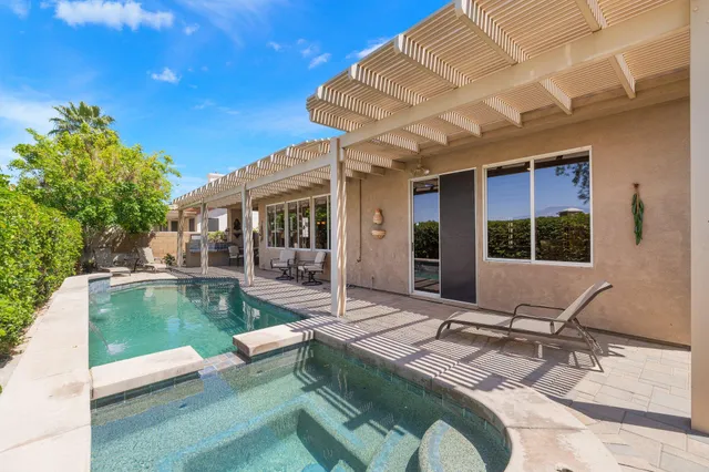 a view of a patio with couches chairs and potted plants