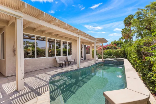 a view of swimming pool with seating space