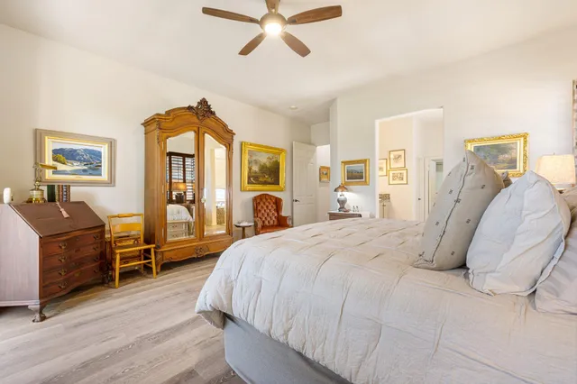 a bed room with a bed and a chandelier