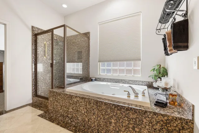 a bathroom with a bathtub and a shower