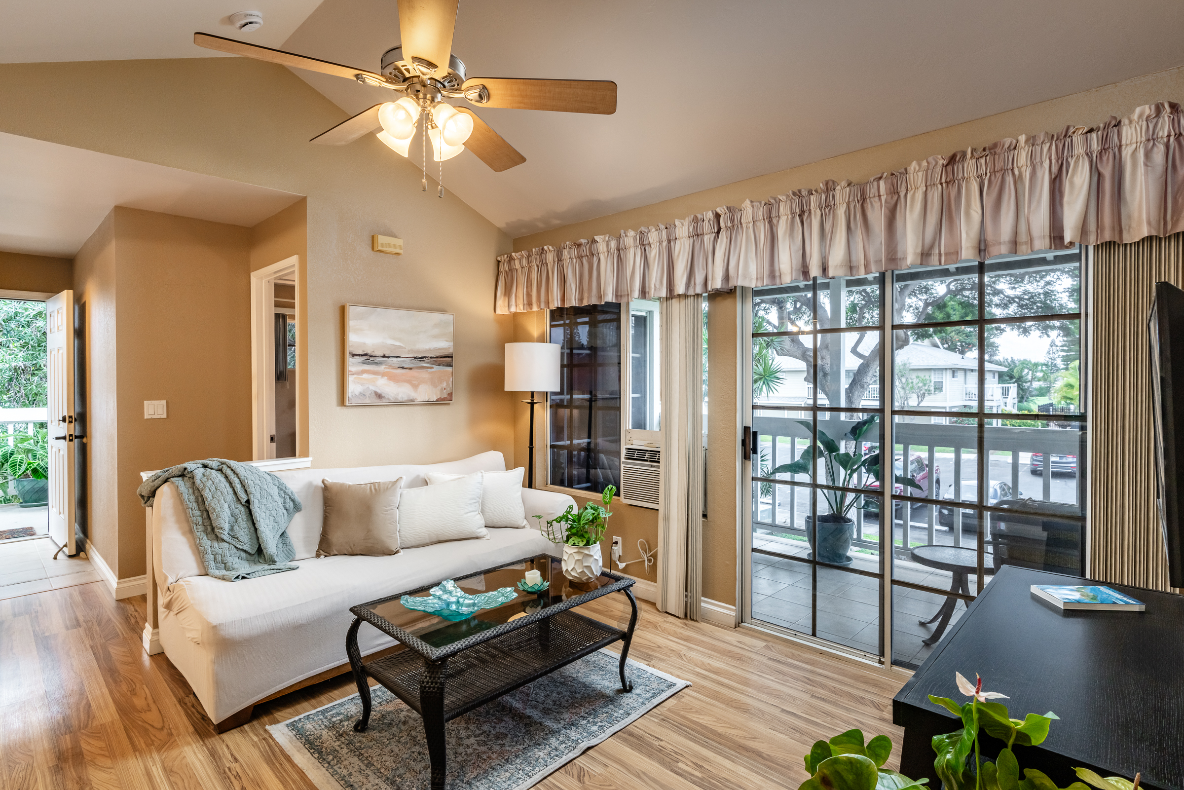 68-3883 Lua Kula Street, Unit 2106 Waikoloa, HI 96738 - Photo 2 of 13 a living room with furniture a chandelier and a floor to ceiling window